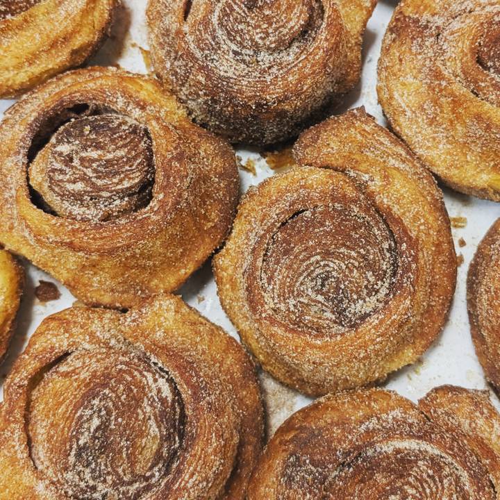 Freshly baked cinnamon pastries coated with sugar